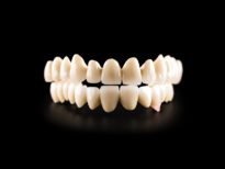 Dental ceramic bridge on isolated black background